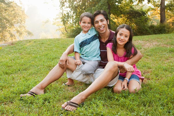 dad with son and daughter sitting outside